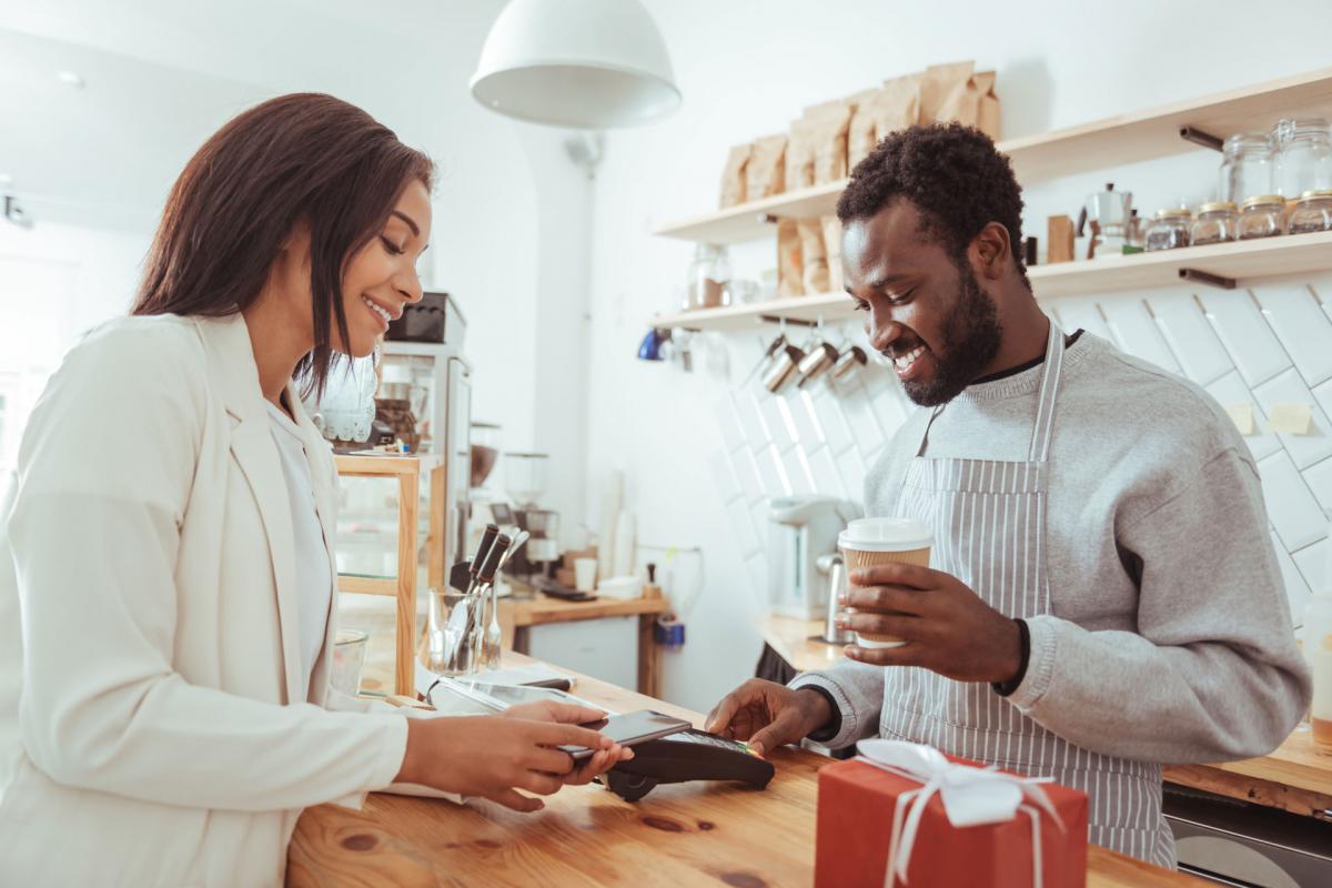 Woman paying for coffee using her phone